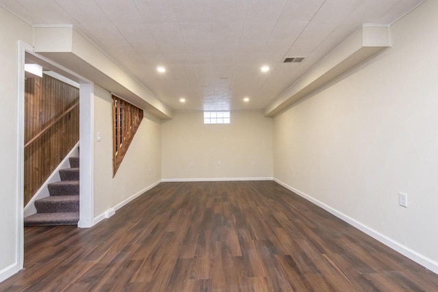 basement featuring dark hardwood / wood-style flooring