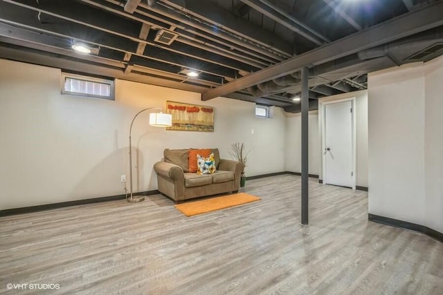 basement with light hardwood / wood-style flooring