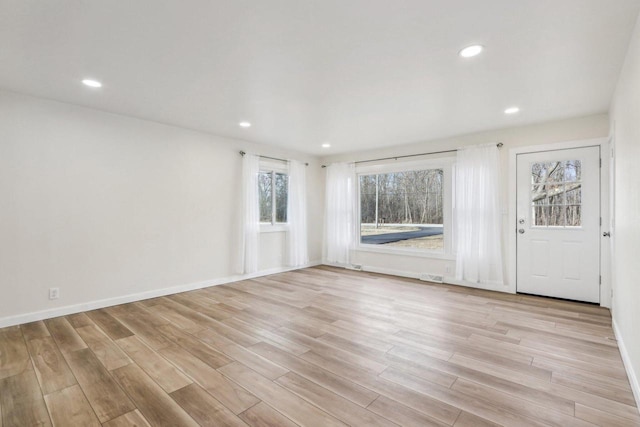 empty room with light hardwood / wood-style flooring