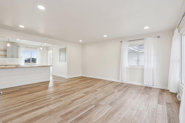 unfurnished living room with light wood-type flooring