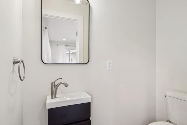 bathroom featuring vanity and toilet