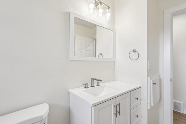 bathroom with vanity and toilet