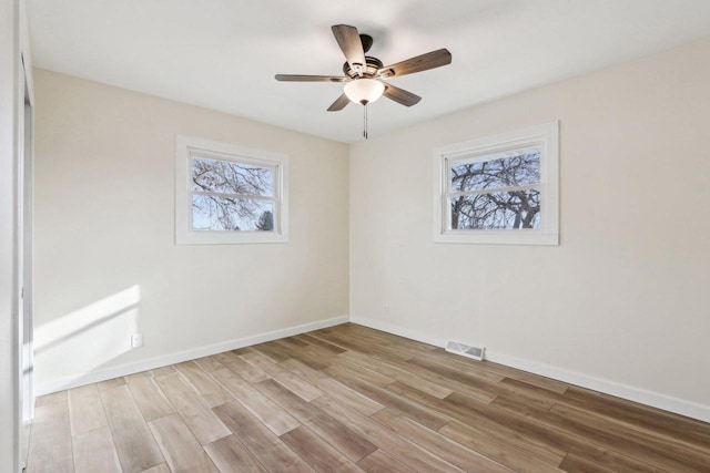 unfurnished room featuring plenty of natural light, light hardwood / wood-style floors, and ceiling fan