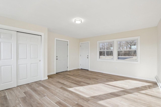 unfurnished bedroom featuring light wood-type flooring