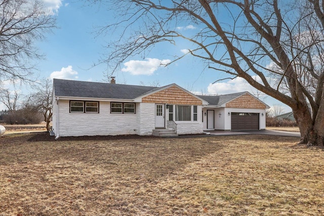 ranch-style house with a garage and a front yard