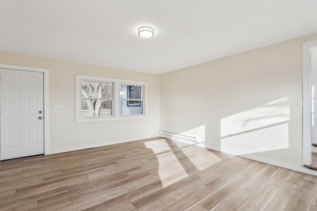 unfurnished room with light wood-type flooring and baseboard heating