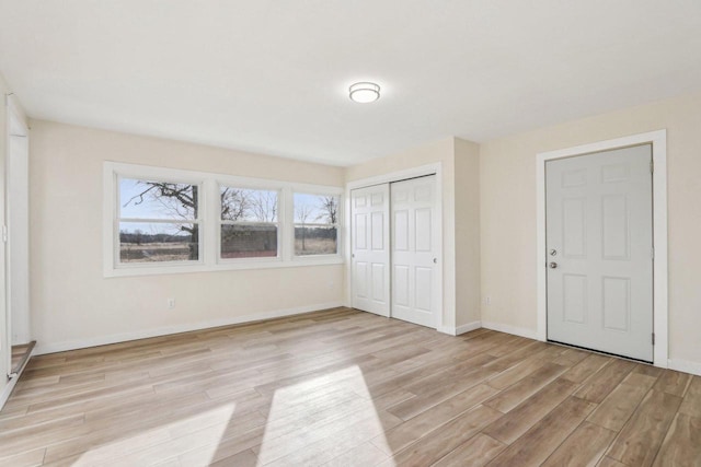 unfurnished bedroom with a closet and light hardwood / wood-style flooring