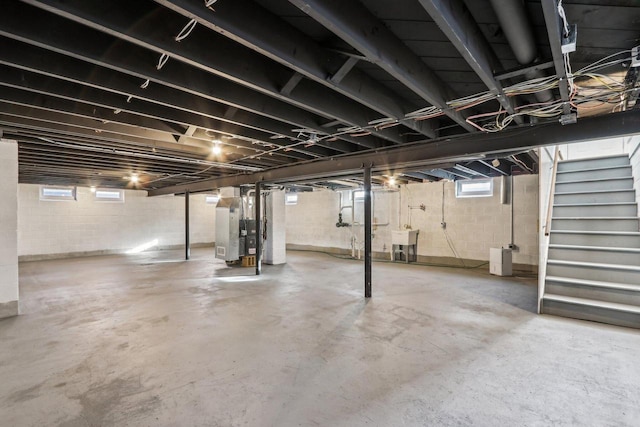 basement featuring sink and heating unit