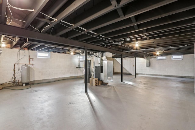 basement featuring heating unit and electric panel