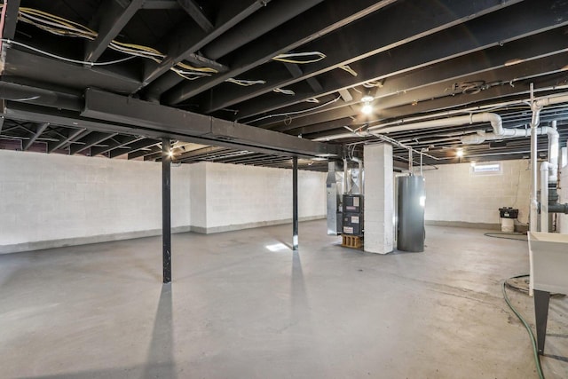 basement featuring water heater and heating unit