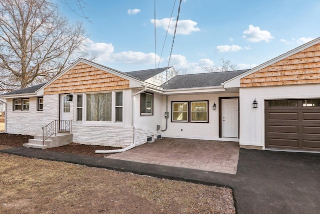 ranch-style home featuring a garage