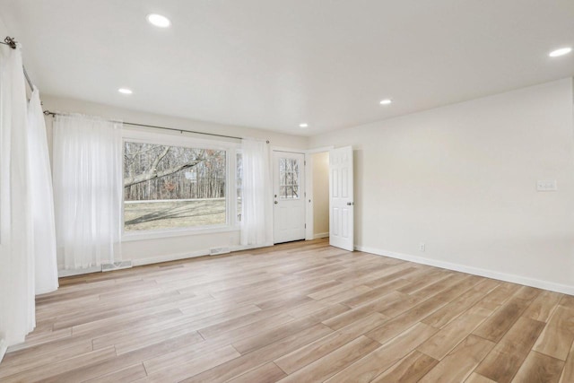 unfurnished room with light wood-type flooring