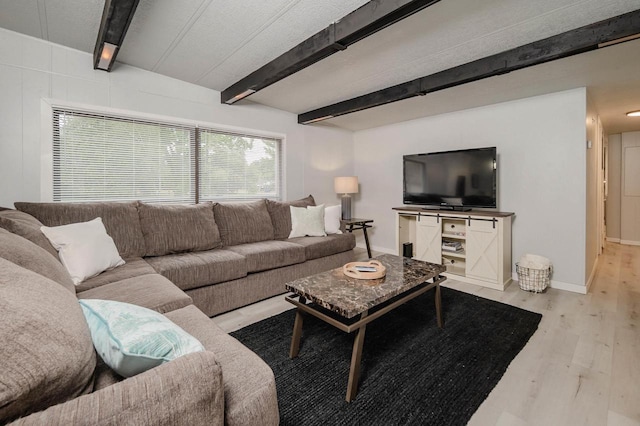 living room featuring beam ceiling and light hardwood / wood-style floors