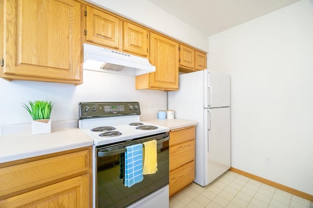 kitchen with baseboards, electric stove, freestanding refrigerator, light countertops, and under cabinet range hood