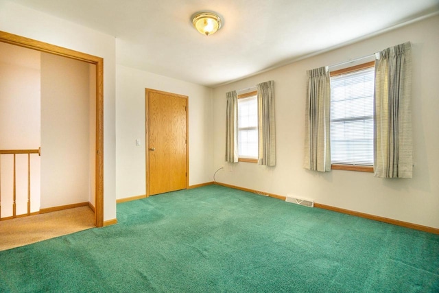 unfurnished bedroom featuring carpet floors, visible vents, and baseboards