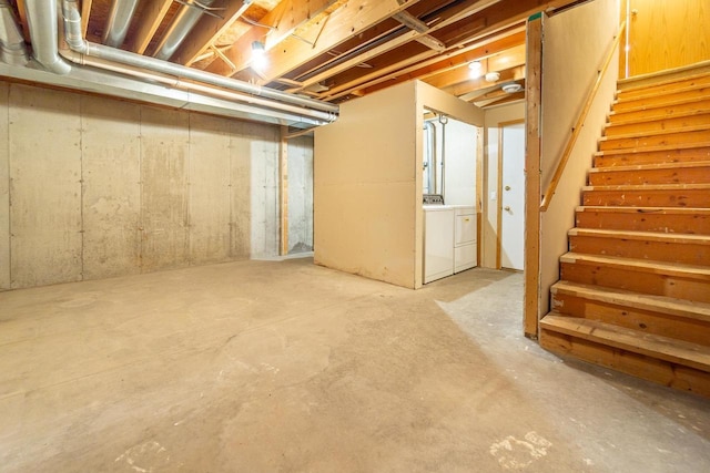 unfinished below grade area featuring washer and dryer and stairs