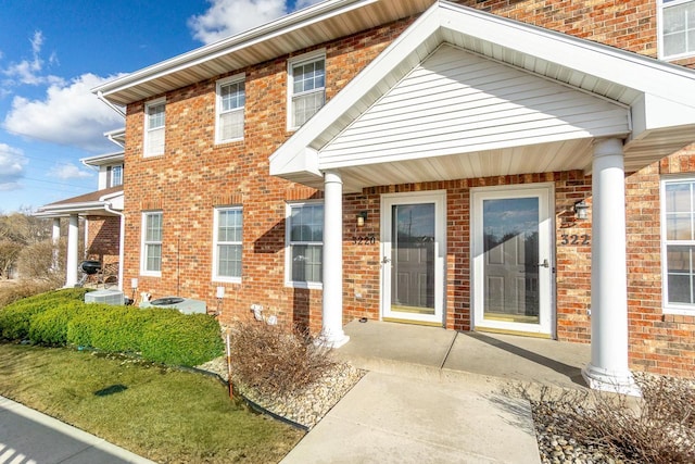 entrance to property featuring brick siding