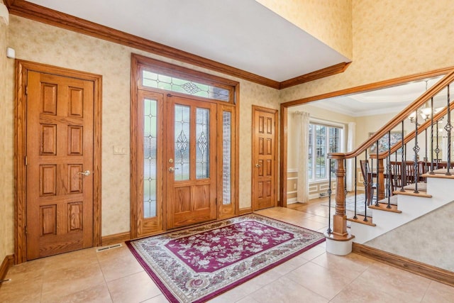 foyer featuring ornamental molding and light tile patterned flooring