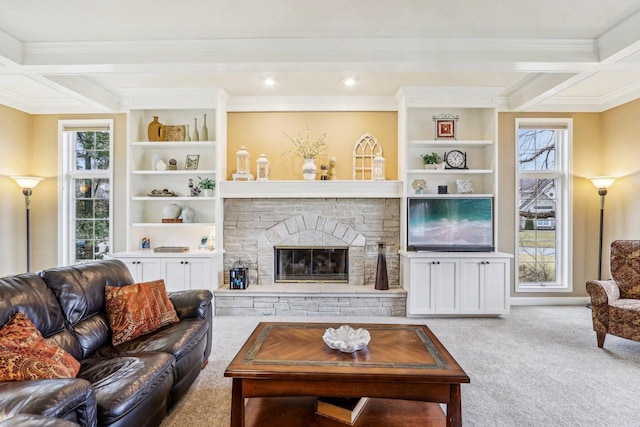 living room with a fireplace, ornamental molding, light carpet, beam ceiling, and built in shelves