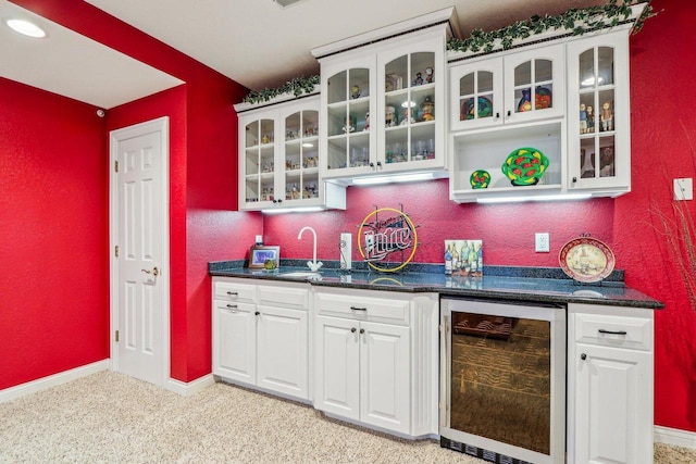 bar with wine cooler, sink, and white cabinetry