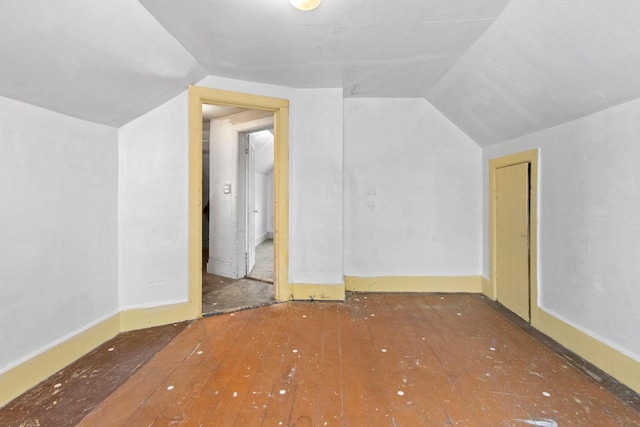 bonus room with vaulted ceiling and hardwood / wood-style floors