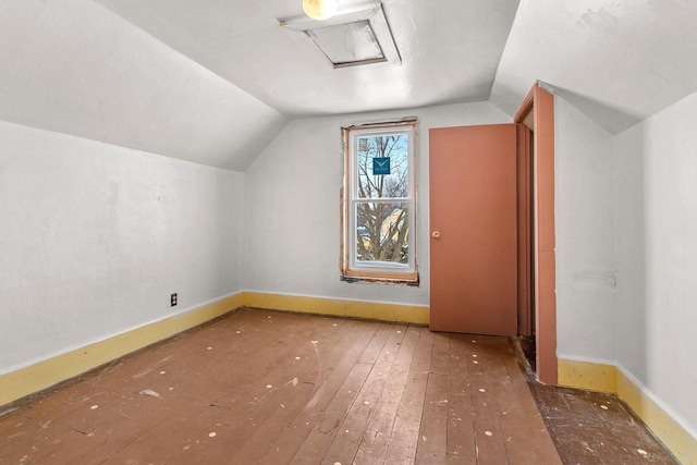 bonus room with wood-type flooring and vaulted ceiling