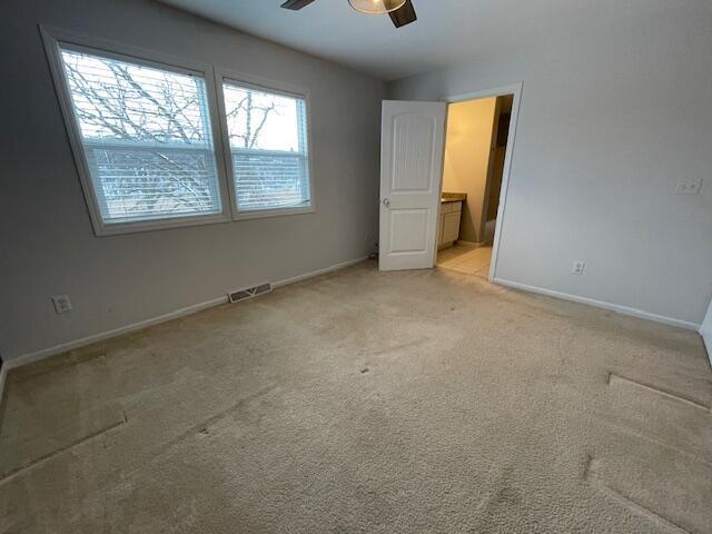 interior space with ceiling fan