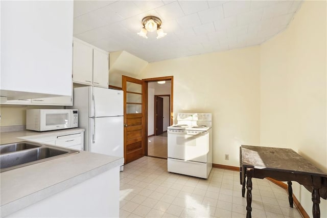 kitchen featuring white cabinetry and white appliances