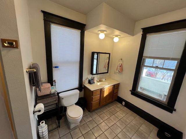 bathroom with vanity, toilet, and tile patterned flooring