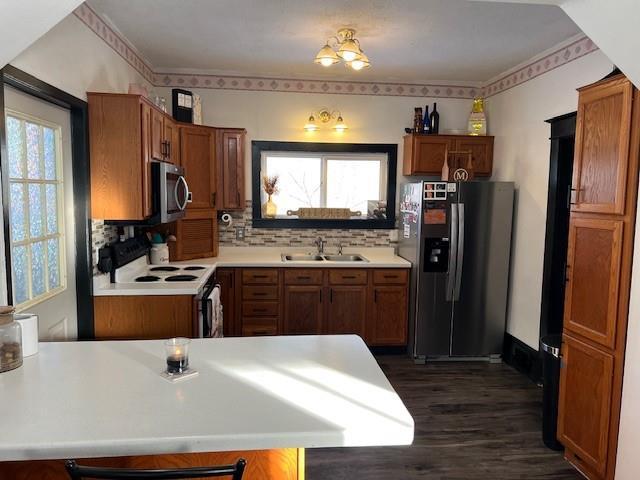 kitchen with sink, decorative backsplash, plenty of natural light, and stainless steel appliances