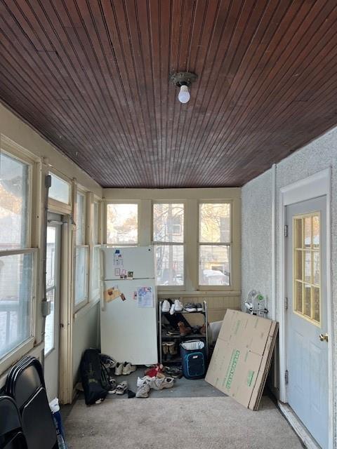 sunroom featuring plenty of natural light and wooden ceiling