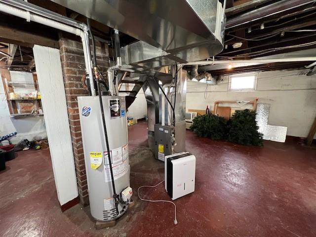 utility room featuring water heater and heating unit