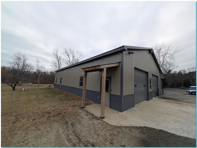 view of home's exterior with a detached garage