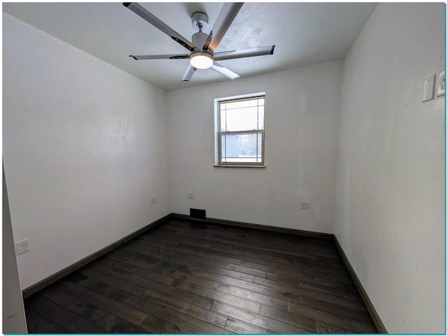 3067 N River Rd, Oconto, WI 54153 - unfurnished room featuring dark wood-type flooring, baseboards, and a ceiling fan