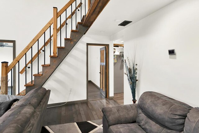 3067 N River Rd, Oconto, WI 54153 - living room featuring stairs, wood finished floors, and baseboards