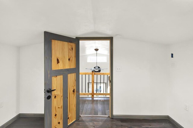3067 N River Rd, Oconto, WI 54153 - spare room with dark wood-type flooring, vaulted ceiling, and baseboards