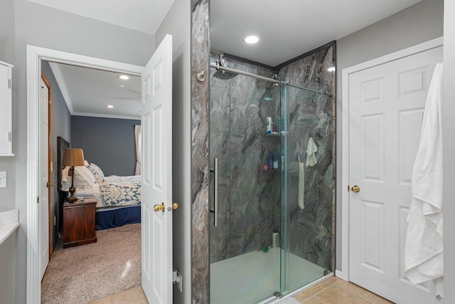 bathroom featuring tile patterned floors, ornamental molding, and a shower with door