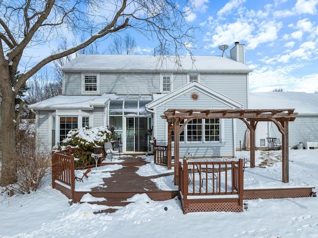 snow covered property featuring a pergola and a deck