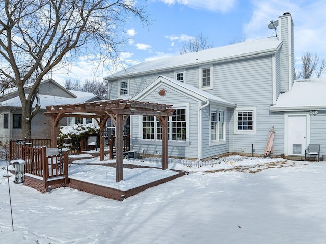 snow covered house featuring a pergola