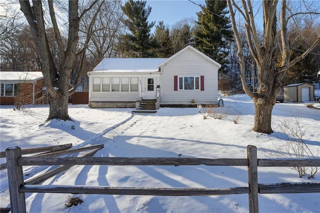 view of front of home with a shed