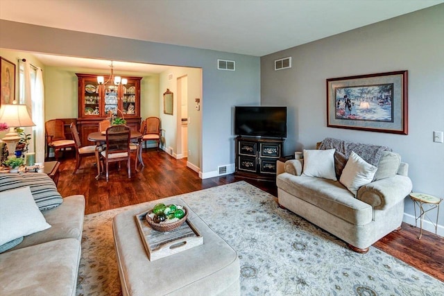 2570 Roanoke Cir, Madison, WI 53719 - living room featuring dark wood-style floors, a chandelier, and baseboards