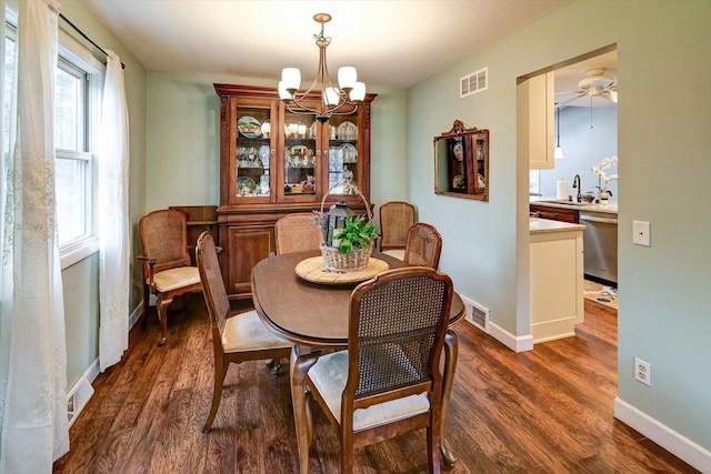 2570 Roanoke Cir, Madison, WI 53719 - dining area with a chandelier, dark wood-style flooring, baseboards, and ceiling fan