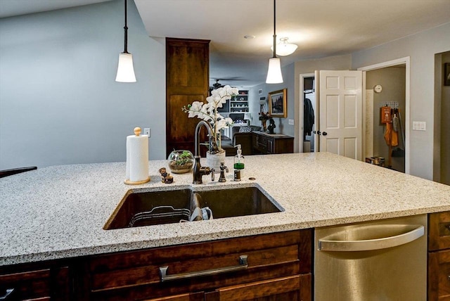 2570 Roanoke Cir, Madison, WI 53719 - kitchen featuring a sink, stainless steel dishwasher, light stone counters, and hanging light fixtures