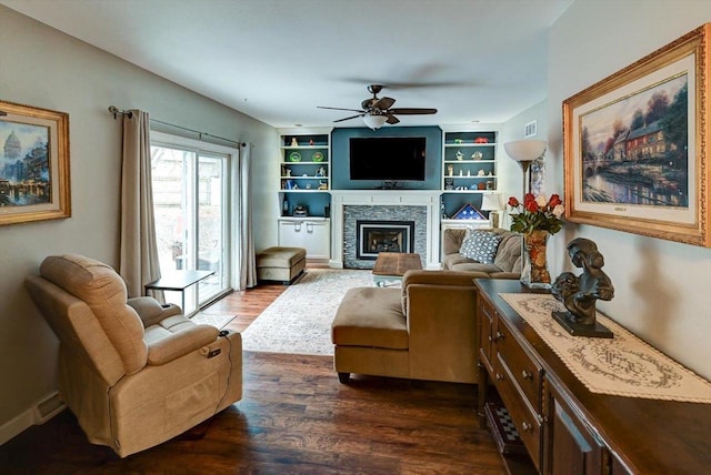 2570 Roanoke Cir, Madison, WI 53719 - living room featuring ceiling fan, dark wood finished floors, a fireplace, and built in features