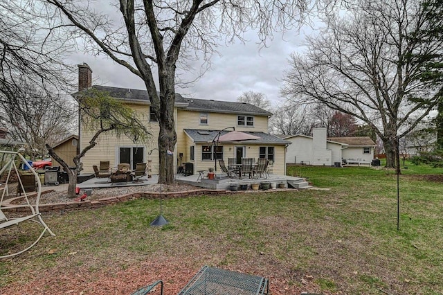 2570 Roanoke Cir, Madison, WI 53719 - back of house featuring a chimney, a lawn, outdoor dining area, and a patio area