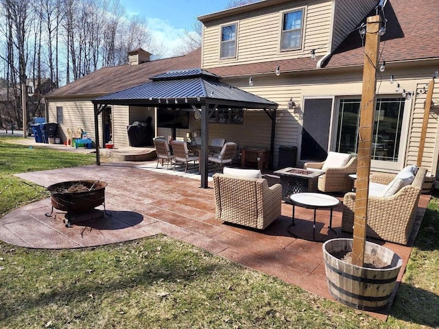 view of patio featuring a gazebo and an outdoor fire pit