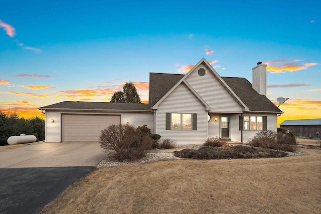 view of front of home with a garage and a yard