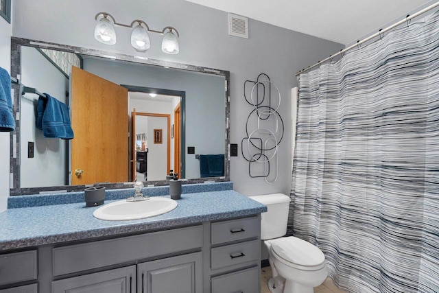 bathroom with vanity, toilet, and a shower with shower curtain