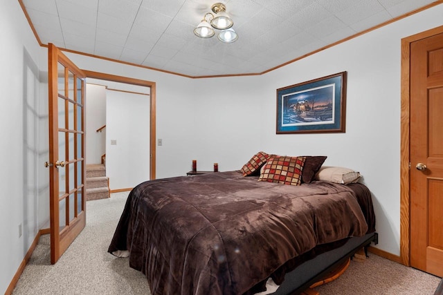 bedroom featuring crown molding and light carpet