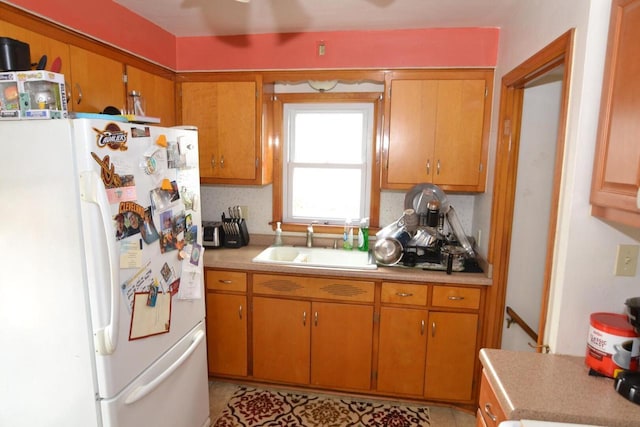 kitchen with sink and white fridge